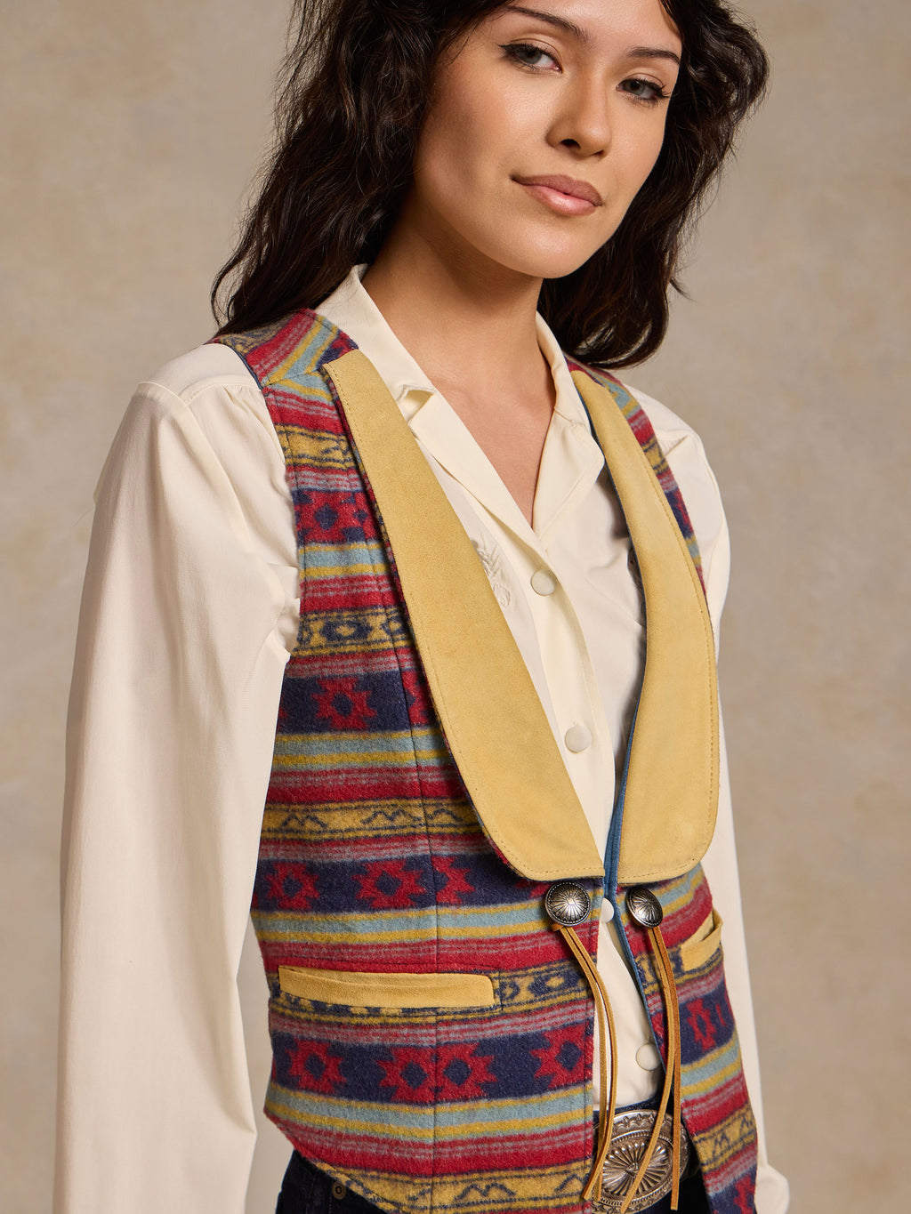 Wool vest with multicolor blanket stripe pattern and tan collar, concho-button front