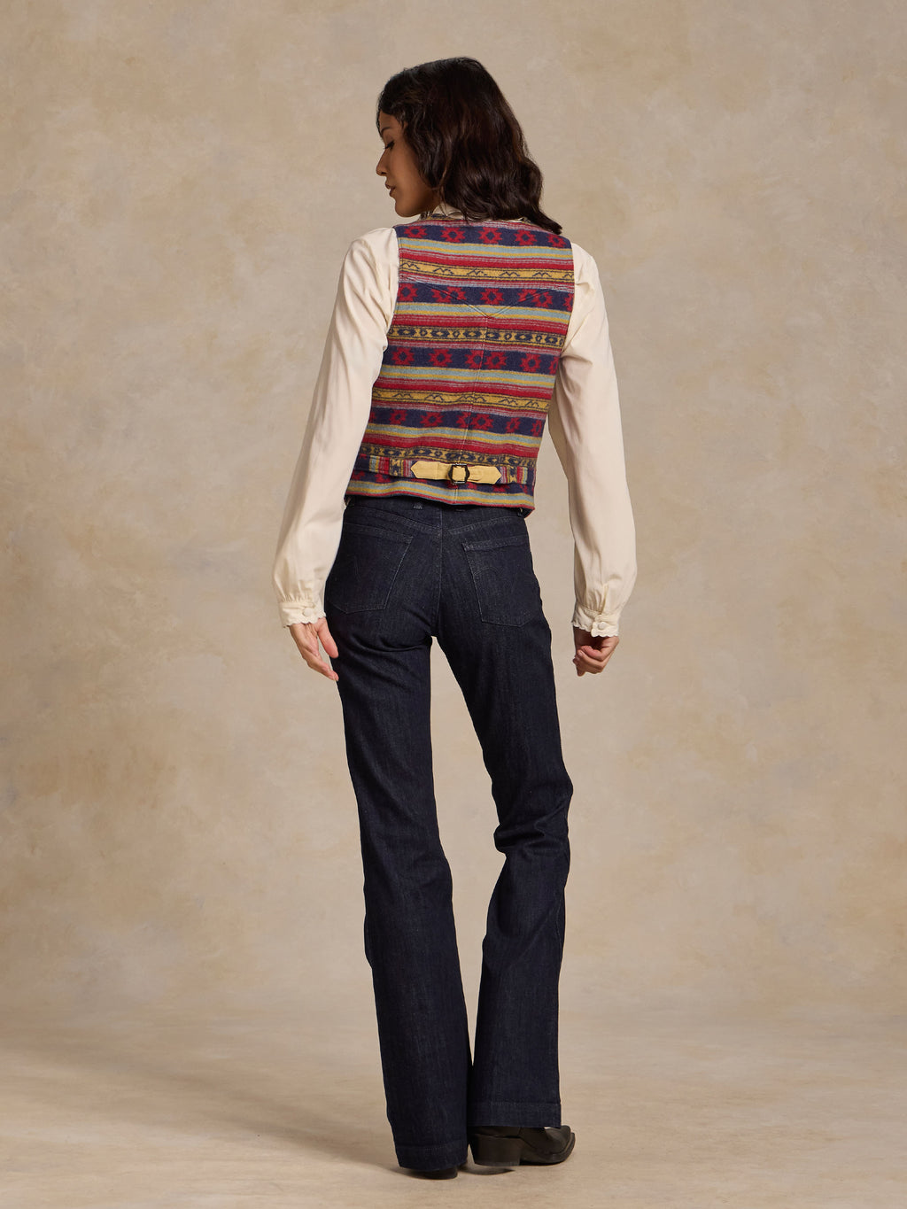 Wool vest with multicolor blanket stripe pattern, tan back yoke, snap-and-lace trim