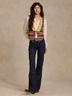Women's patterned wool vest over white shirt; tan V-trim and button front