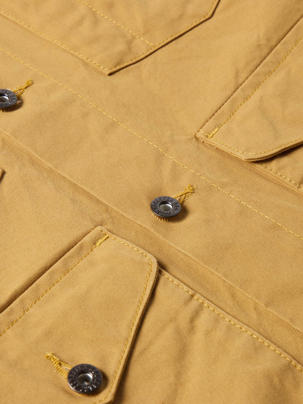 Suntan brush jacket chest detail with flap pockets and snap buttons