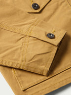 Suntan brush jacket pocket flaps with stitched seams and snap buttons