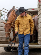 Suntan brush jacket with snap front, chest pockets, and brown collar worn outdoors