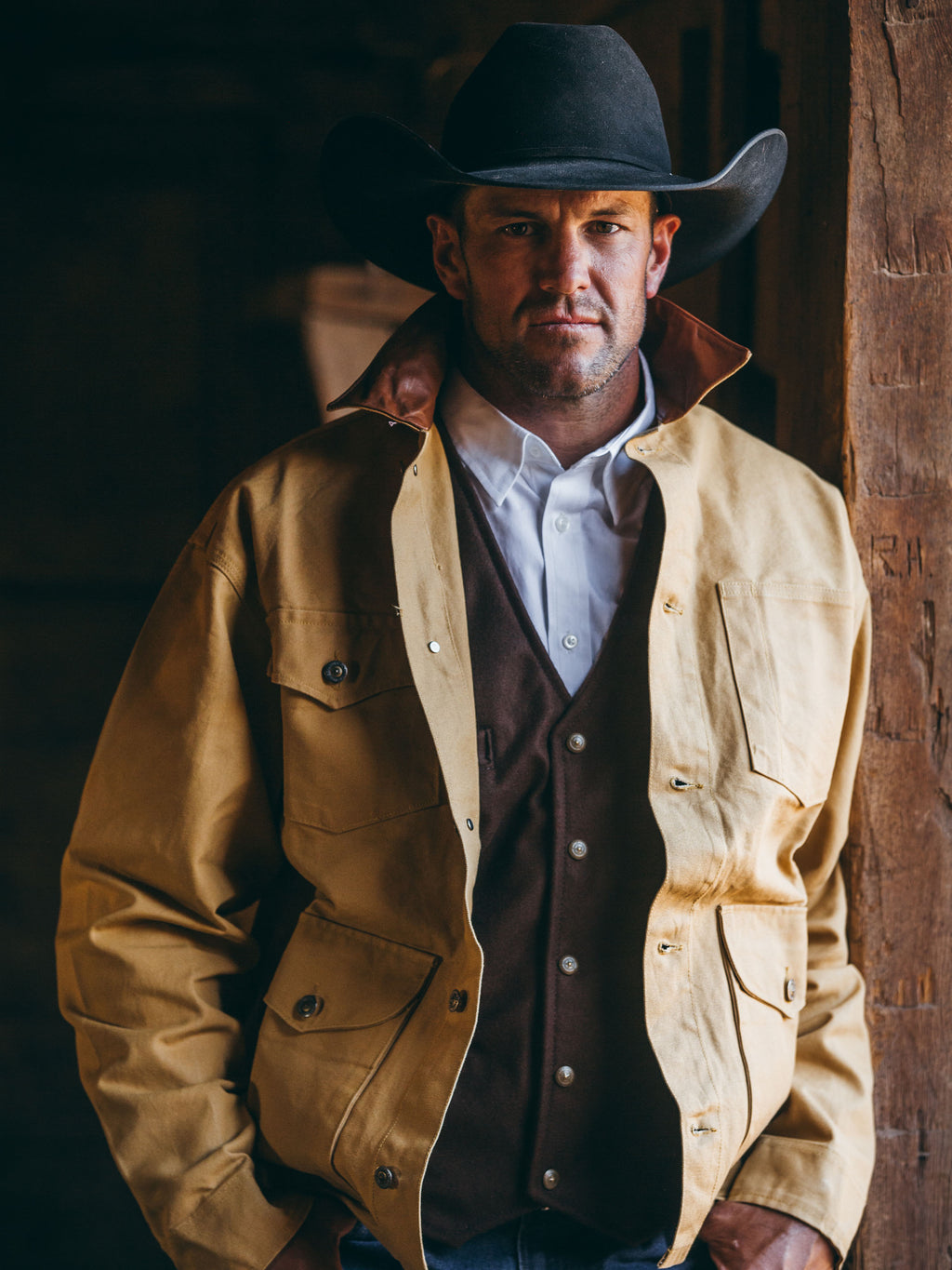 Suntan brush jacket with snap front and brown collar worn by cowboy