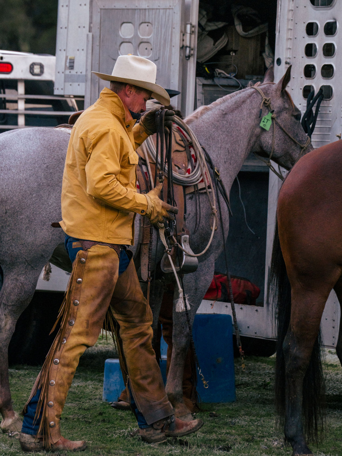 Suntan brush jacket on a cowboy working near a horse, snap-front pockets