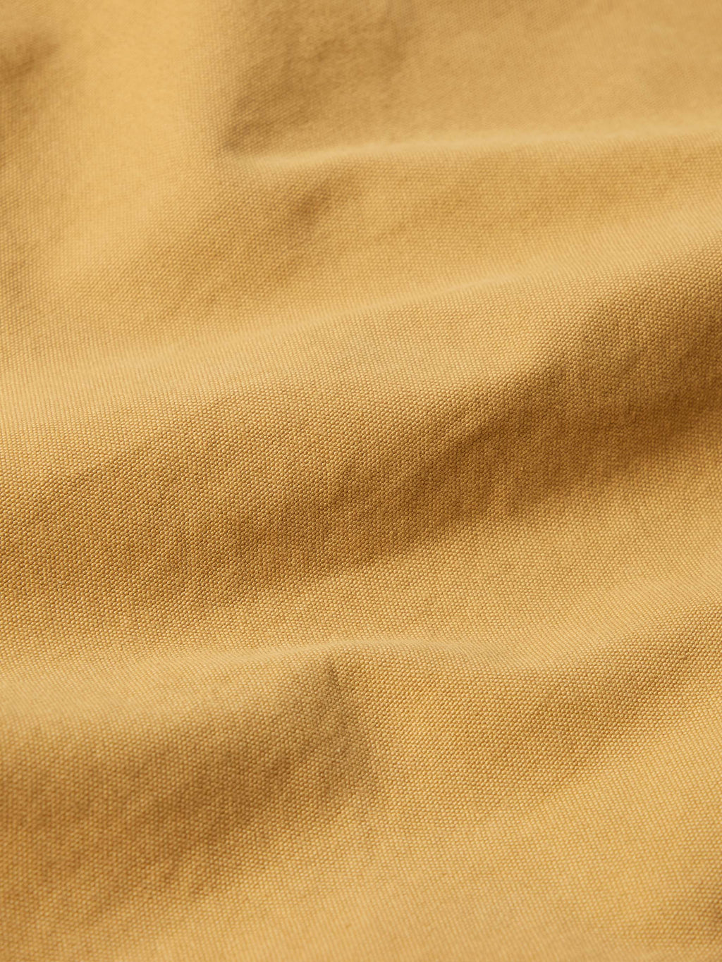 Suntan brush jacket fabric close-up showing smooth weave texture