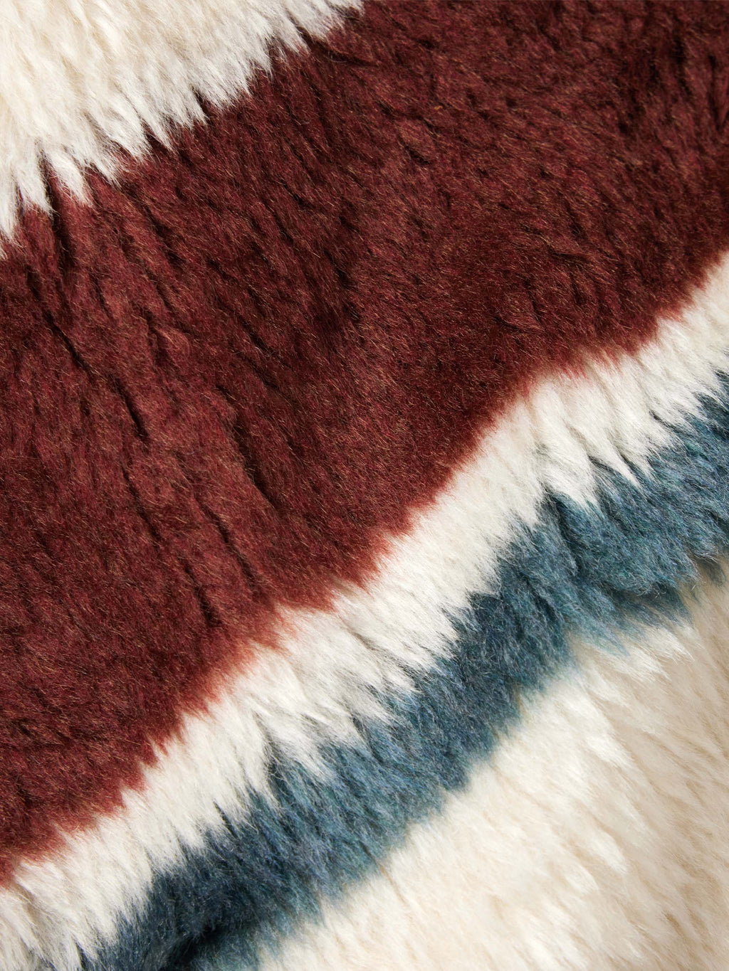 Tri-color faux fur detail with maroon, blue, and cream diagonal stripes.