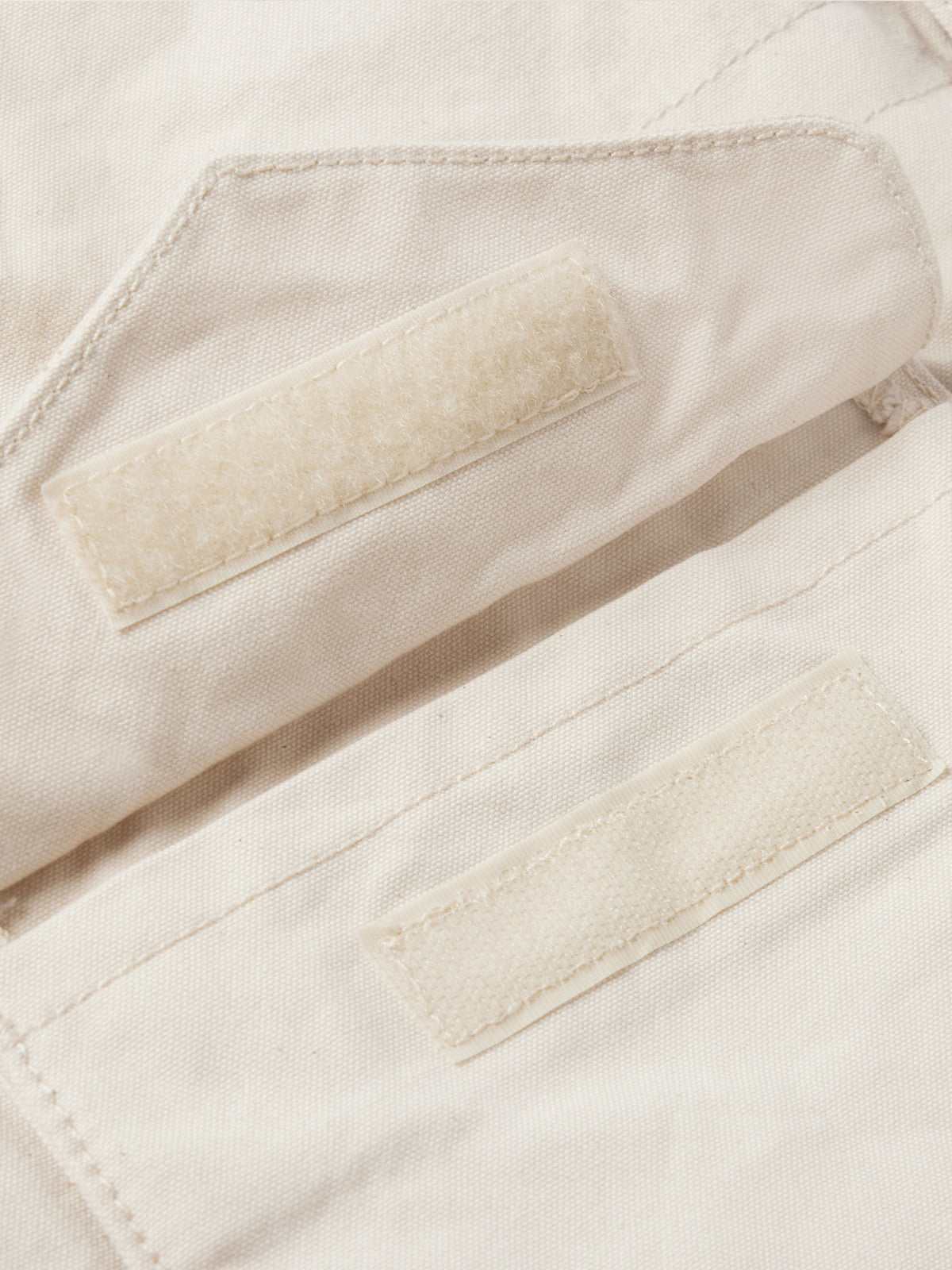 Natural coat interior with tan faux-shearling panels and stitched pockets