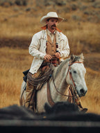 Natural drifter coat on horseback with multicolor striped yoke and white button front