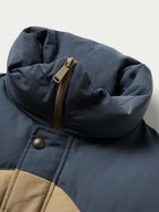Dark navy puffer jacket corner detail with zipper and snap placket