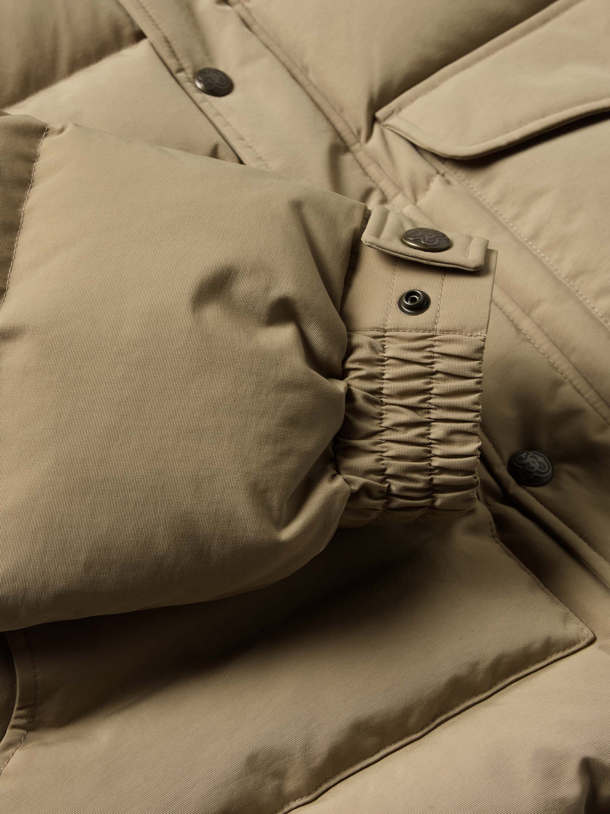 Camel down jacket arm and sleeve detail with snaps and gathered cuff