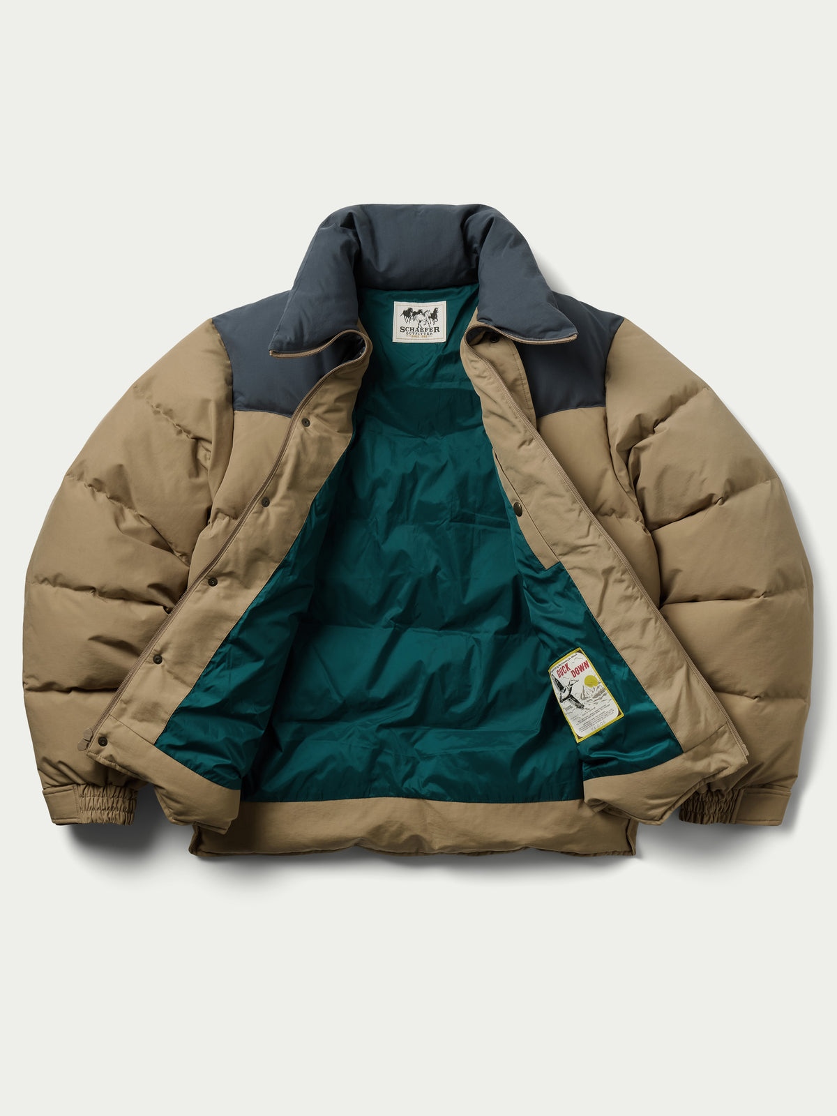 Camel and dark navy puffer down jacket with visible interior lining and tag