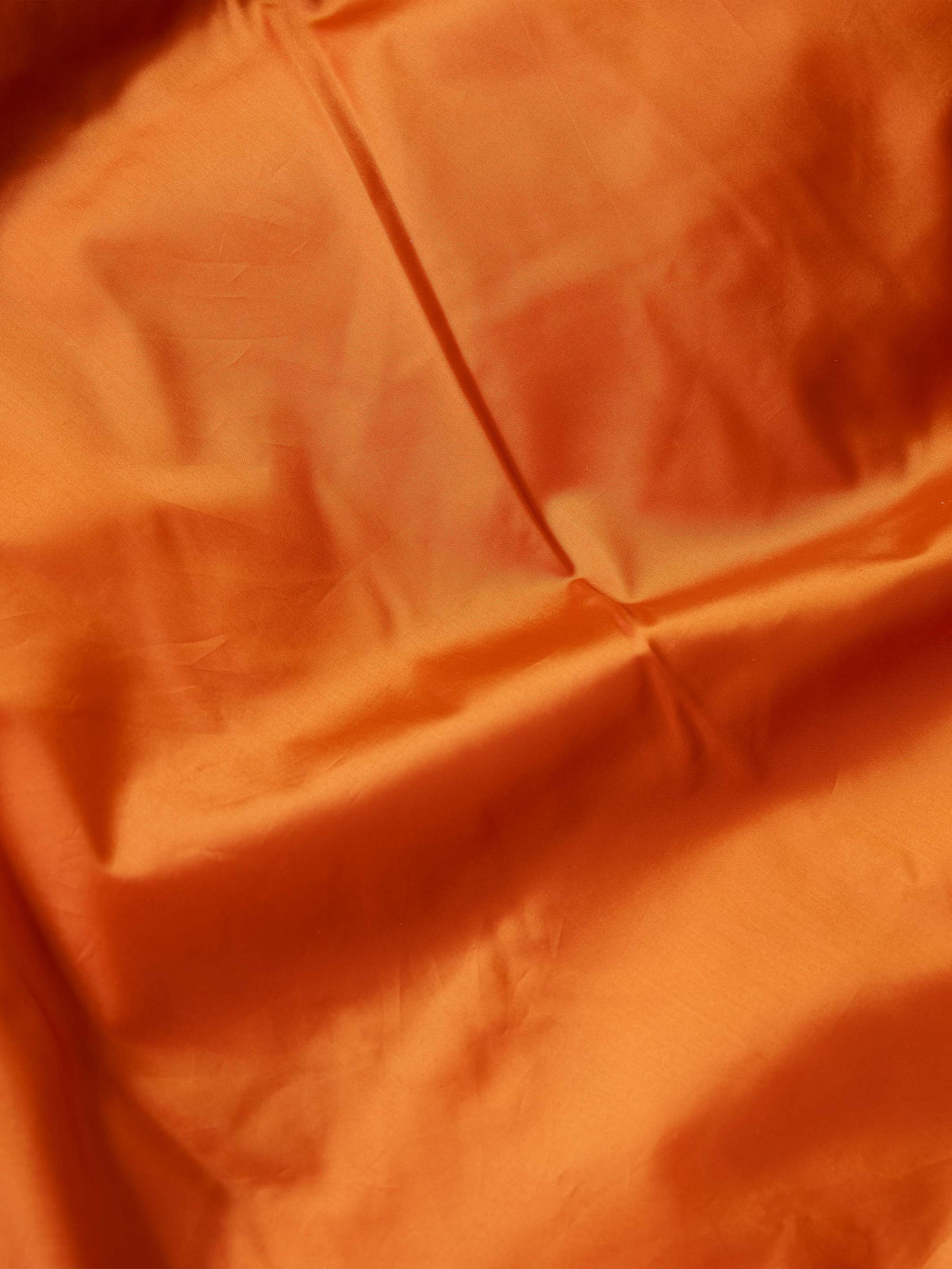 Orange quilted inner lining panel of down jacket