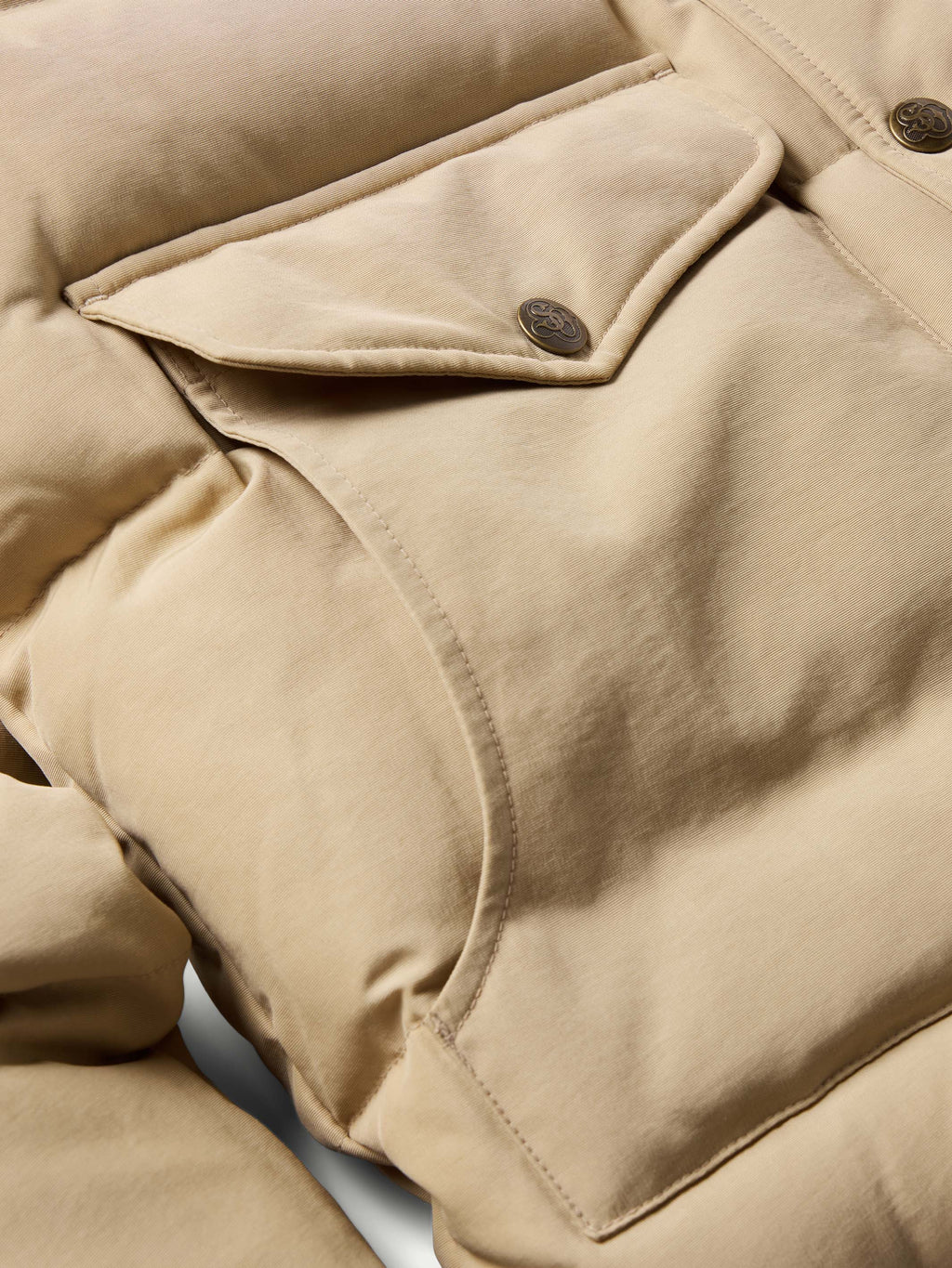 Tan down jacket with snap-button placket and stand collar detail