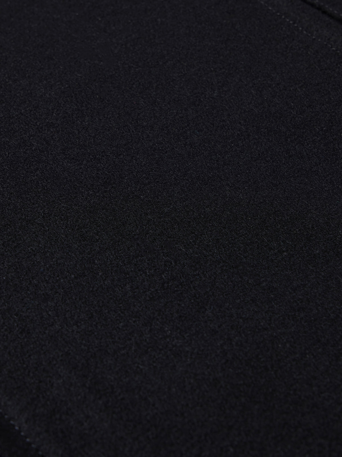 Black wool arena jacket fabric close-up with smooth knit texture