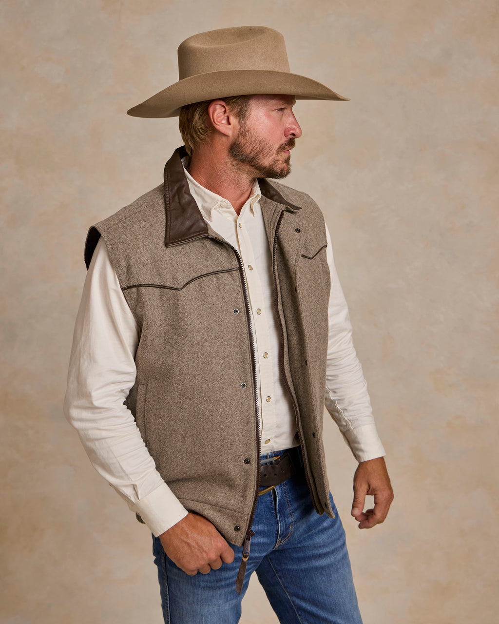 Taupe wool vest with button front, chest pockets, and contrast trim