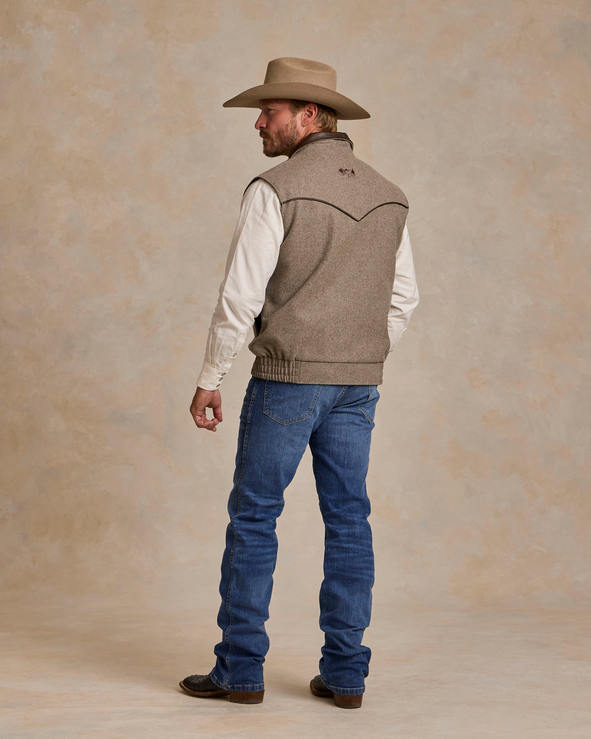 Taupe wool vest back view with ribbed hem and button closure