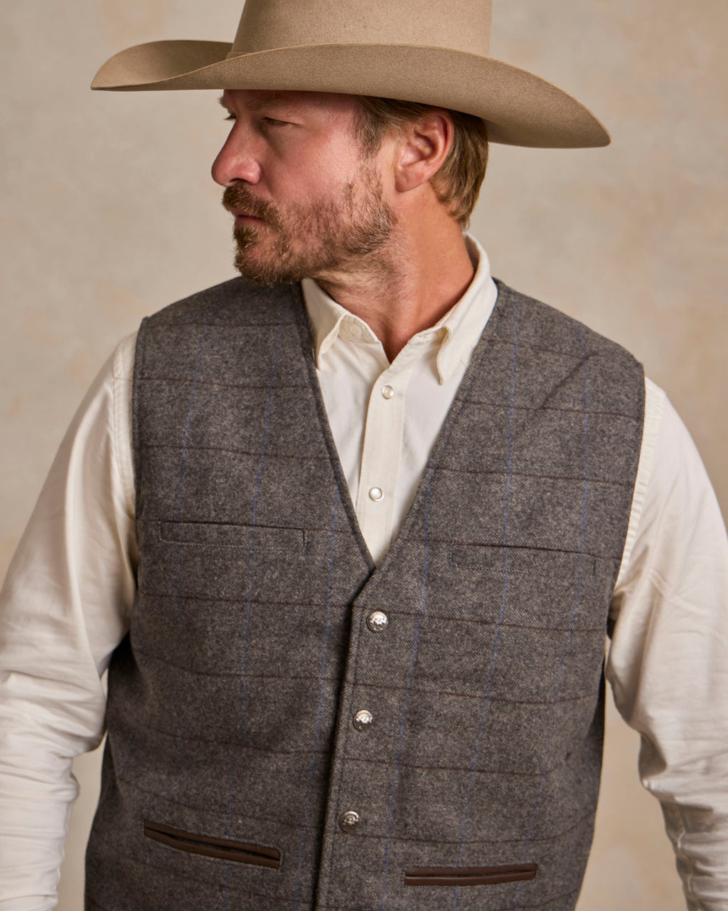 Heather gray windowpane wool vest with V-neck, button closure, and flap pockets