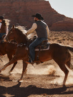 Heather gray windowpane wool vest on horseback rider, V-neck and button front