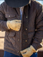 Brown quilted microsuede jacket worn by model, showing stand collar and snap button front.