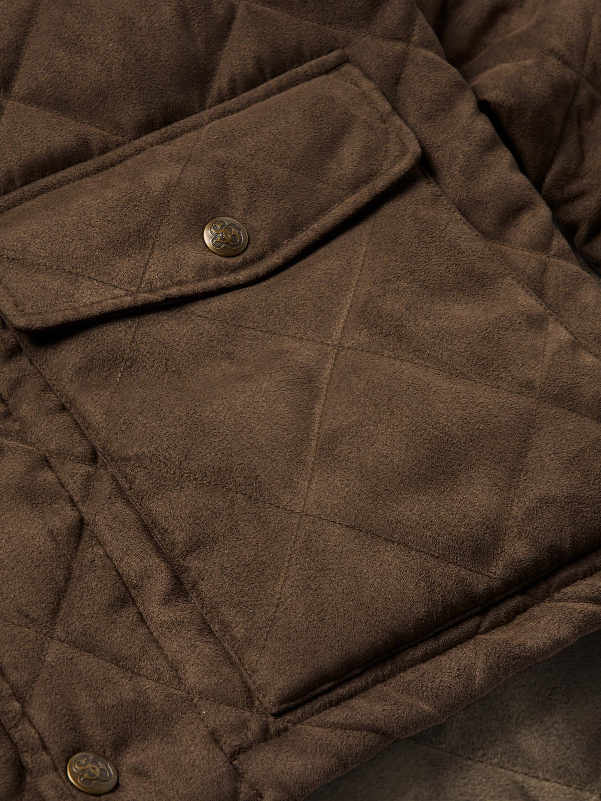 Close-up of brown quilted microsuede jacket chest pocket with metal snap buttons.