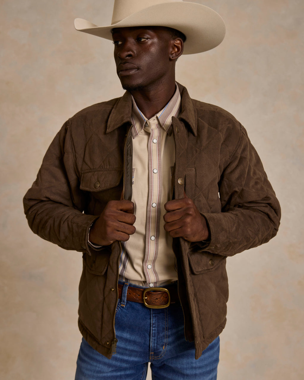 Brown quilted microsuede jacket with stand collar, snap chest pockets, and zip front