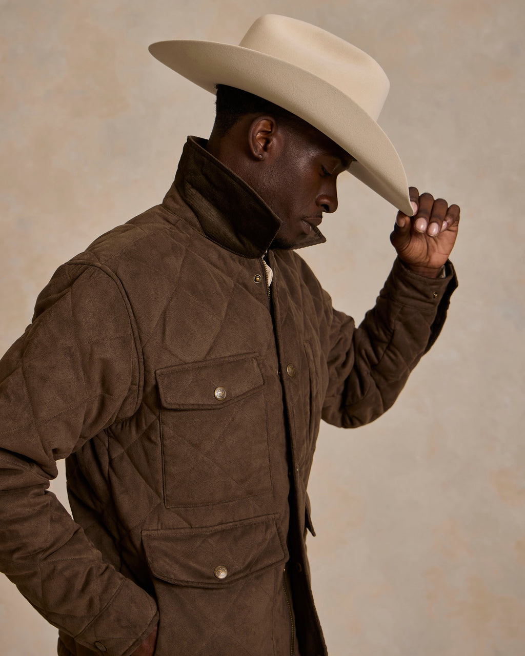 Brown quilted microsuede jacket with stand collar and flap button pockets