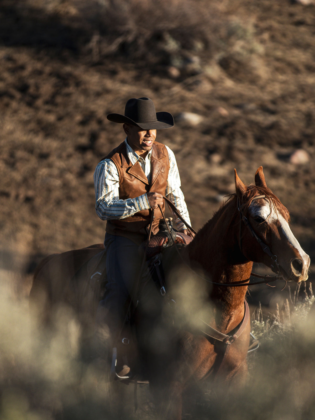 Brown leather cowboy vest with button-front, worn while riding on horseback