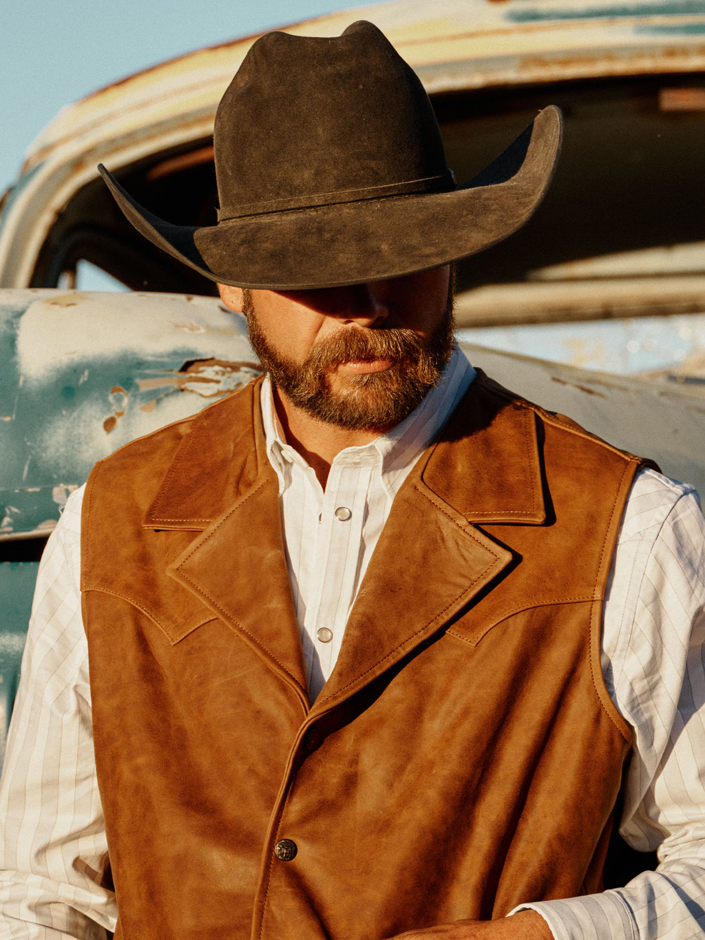 Brown suede Bowie vest with pointed collar, button front, and chest pockets.