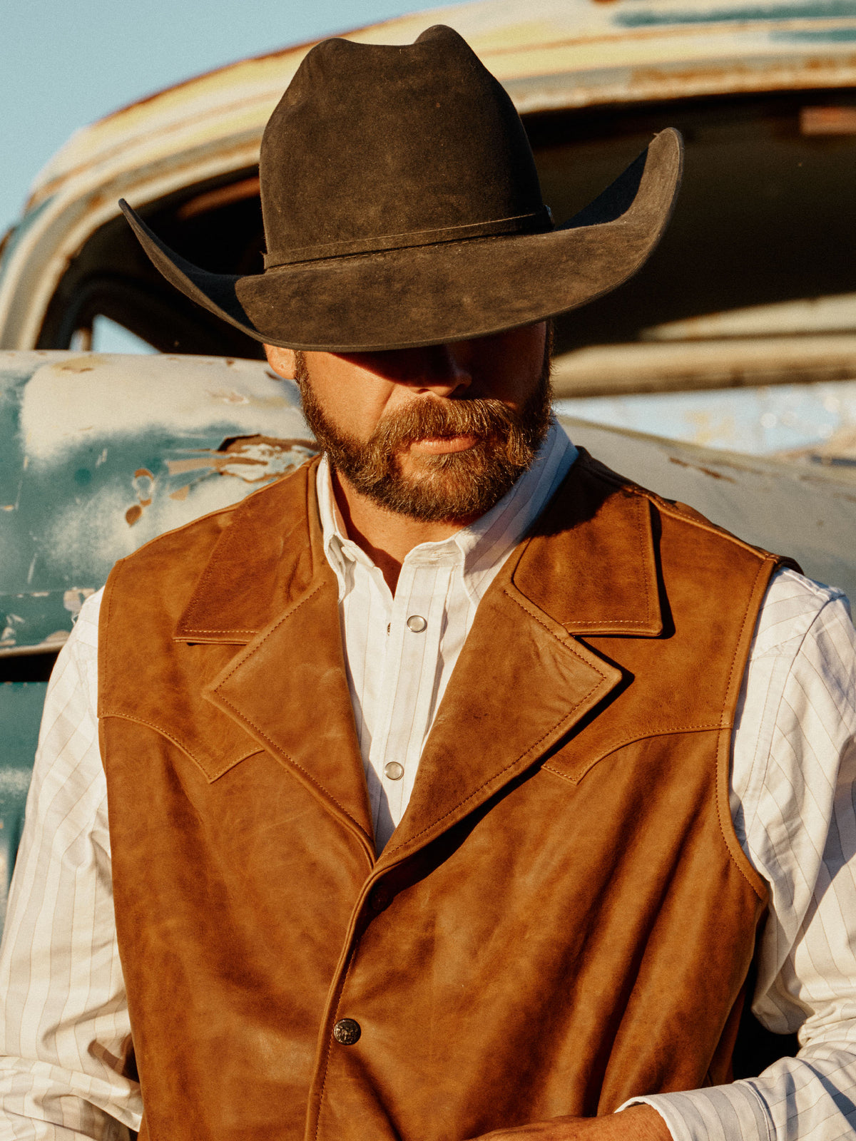 Brown suede Bowie vest with pointed collar, button front, and chest pockets.