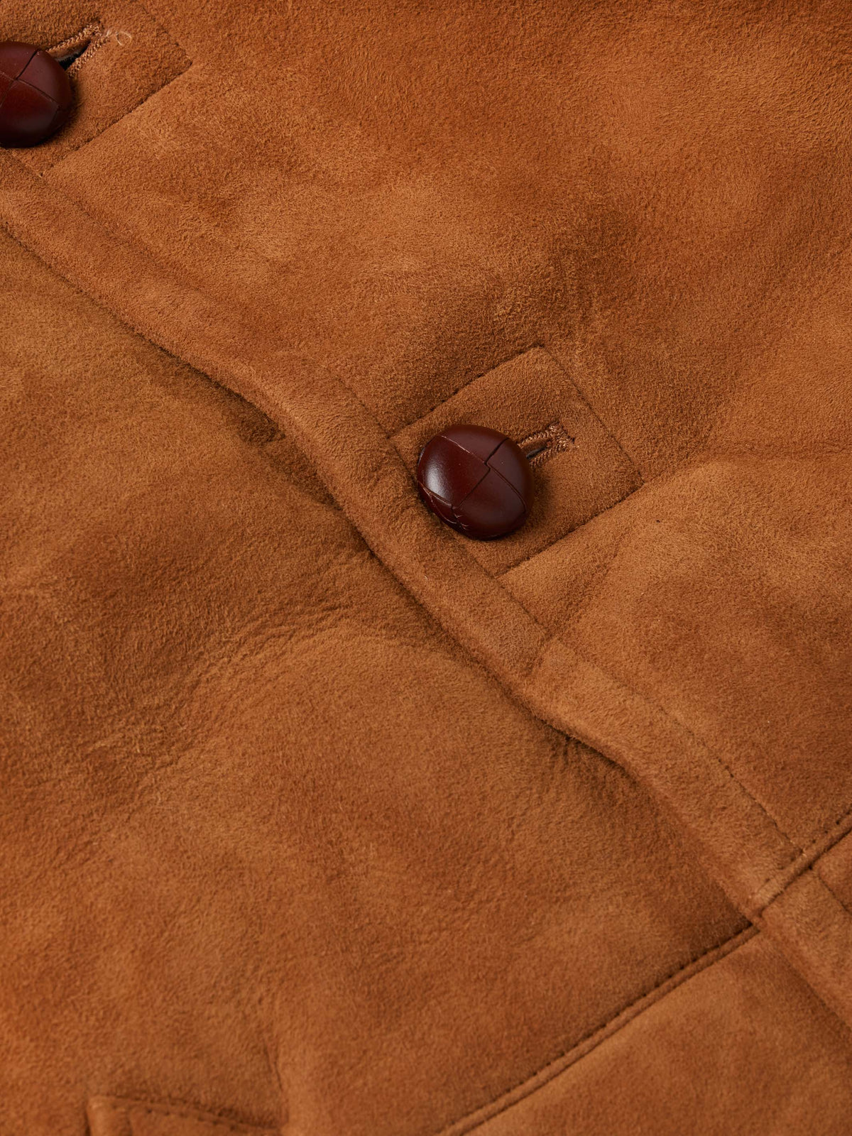 Brown suede shearling coat detail with button placket and soft shearling lining