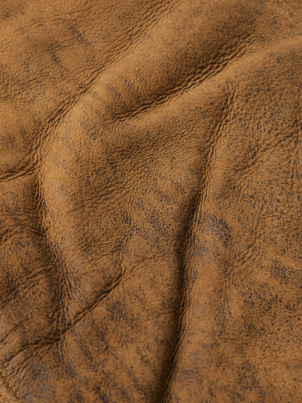 Brown trucker jacket fabric texture close-up