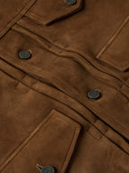 Close-up of brown roughout suede jacket front with snap placket and stitched details