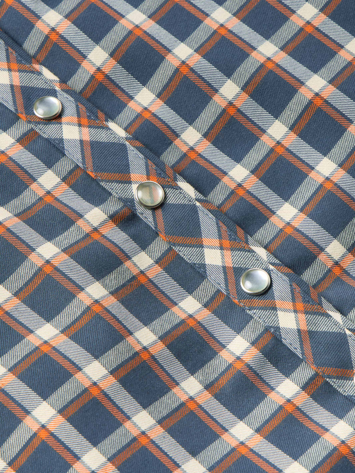 Women’s embroidered snap shirt close-up, sleeve cuff with snap buttons and plaid