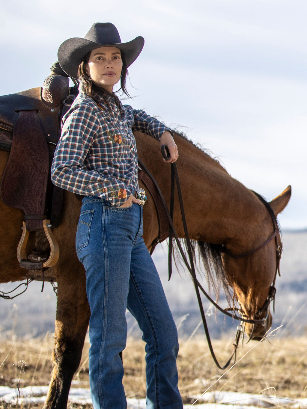 Women’s embroidered snap shirt on model, blue plaid with floral embroidery and snaps