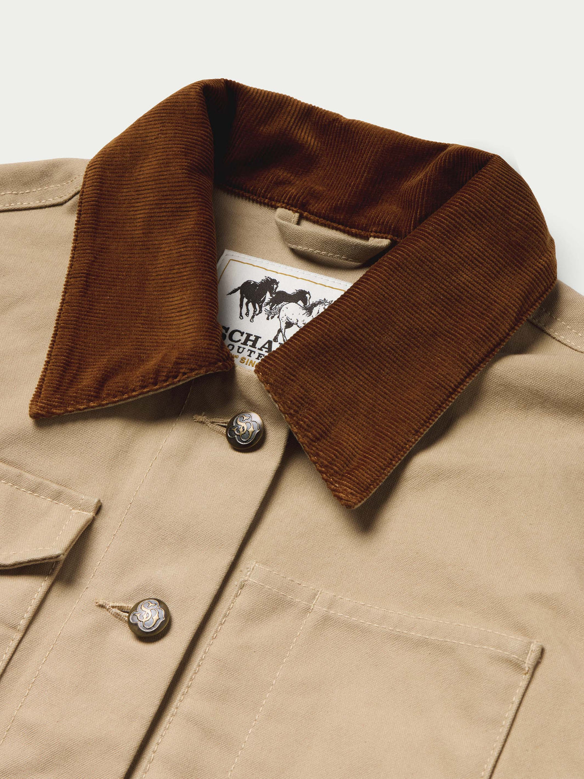 Beige jacket front detail with brown corduroy collar and snap buttons