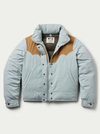 Women’s down jacket front view, light blue with tan panels, hood and snap placket