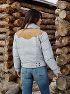 Women’s down jacket back view in light blue with tan yoke and snap-button placket