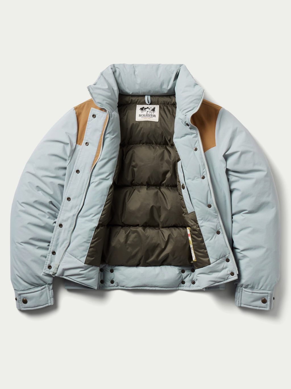Women’s down jacket open front showing quilted brown interior lining