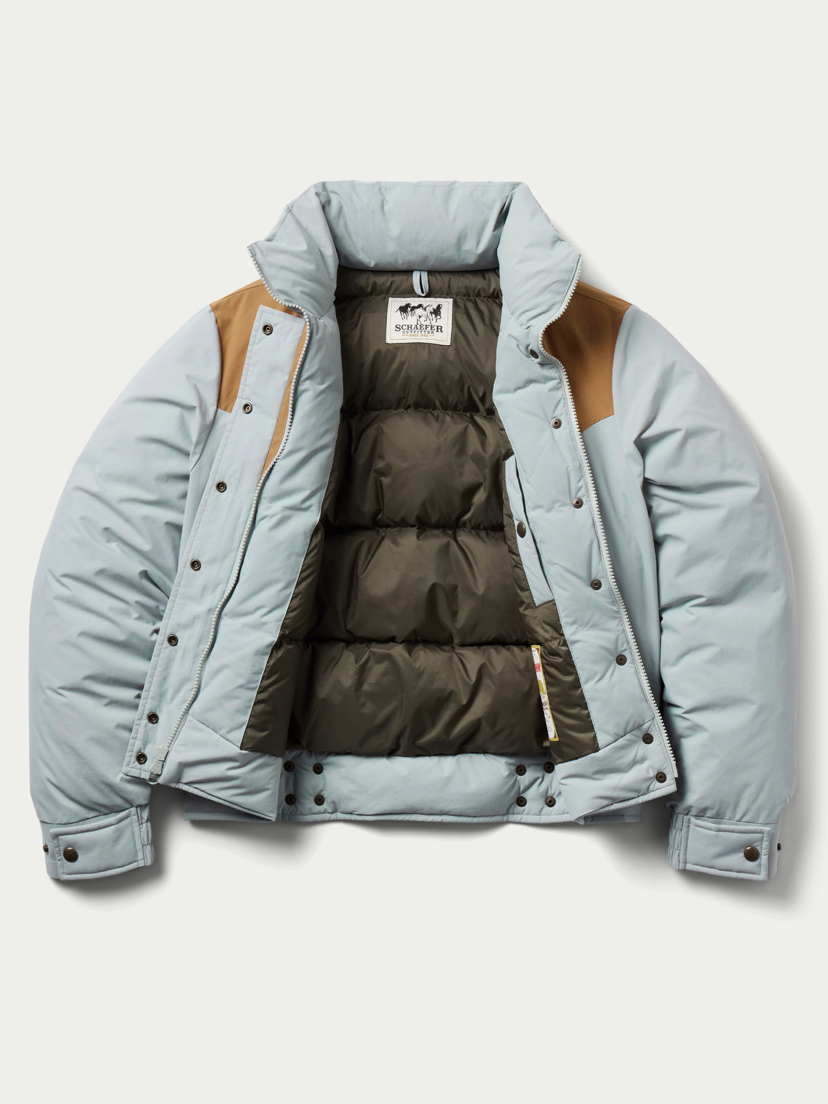 Women’s down jacket open front showing quilted brown interior lining