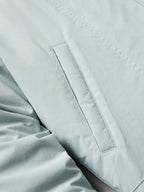 Women’s down jacket close-up of light blue pocket panel and stitched trim