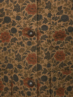 Chore coat fabric detail with floral pattern and two metal snap buttons