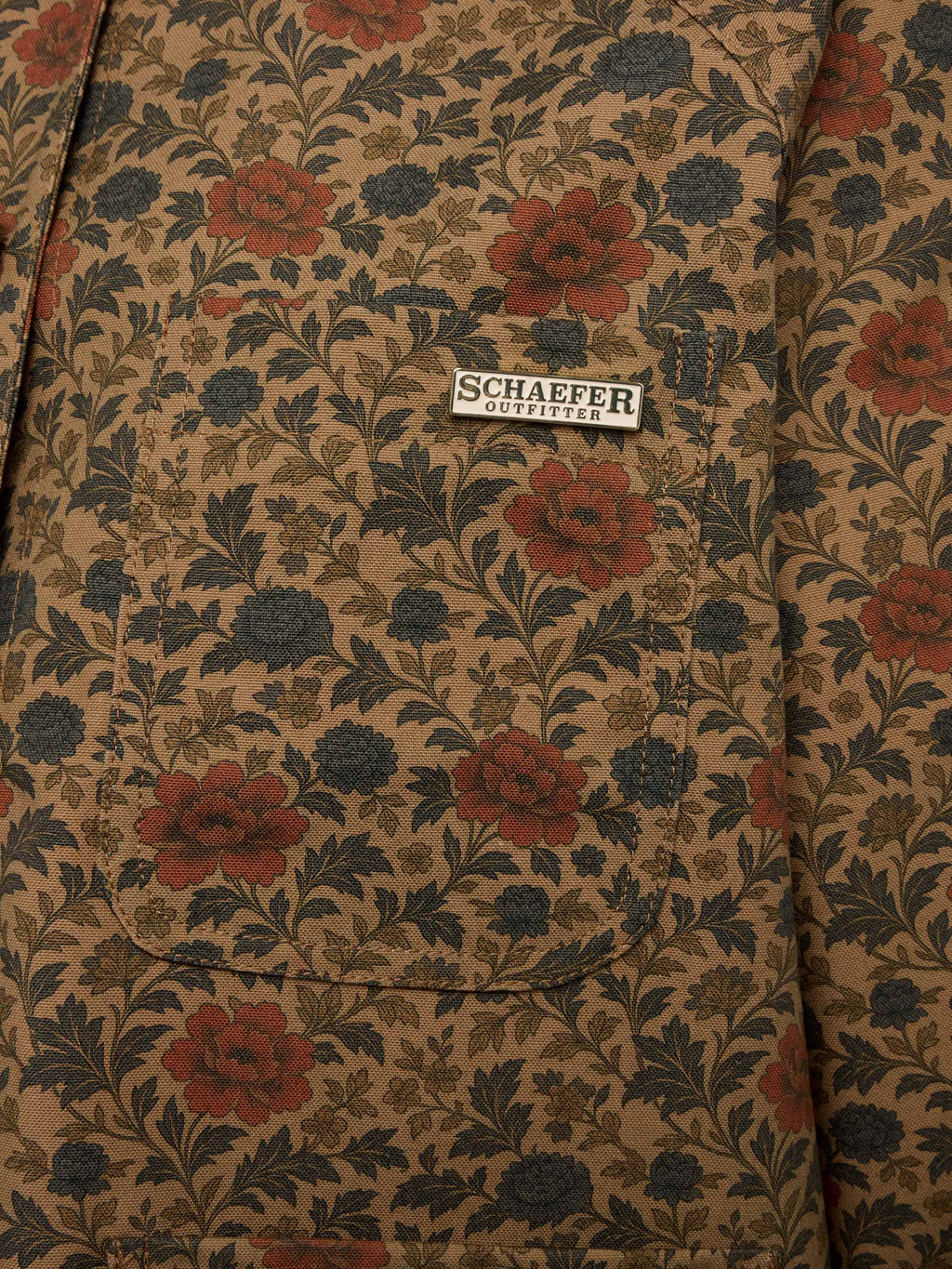 Chore coat interior label on floral fabric with button placket stitching