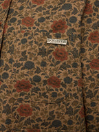 Chore coat interior label on floral fabric with button placket stitching