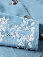 Light wash denim sleeve with white floral and star bead-embroidered design