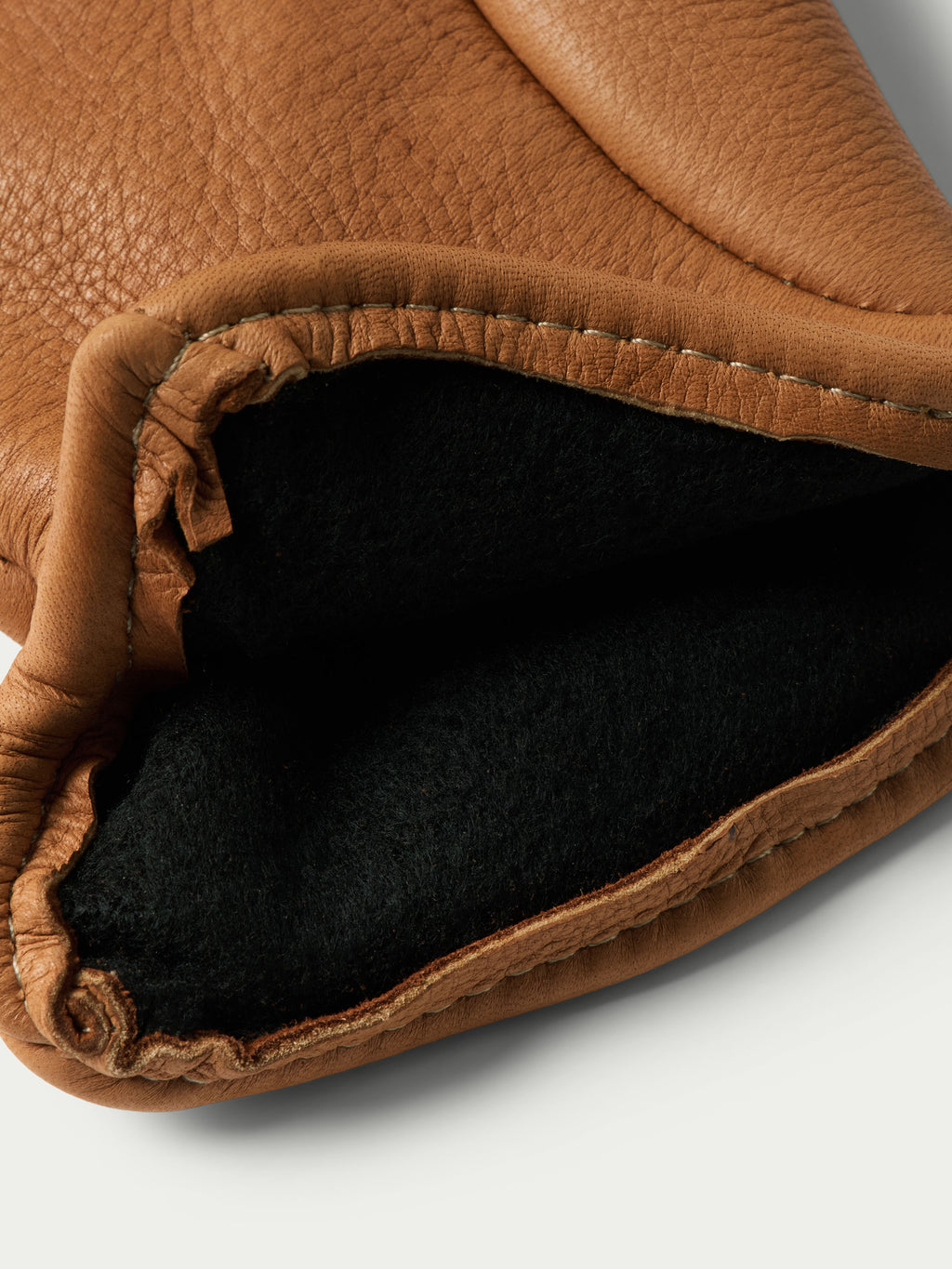 Saddle deerskin insulated glove cuff with dark fleece lining detail