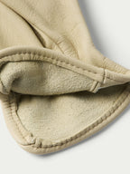 Natural goatskin glove cuff close-up with stitched band and soft lining