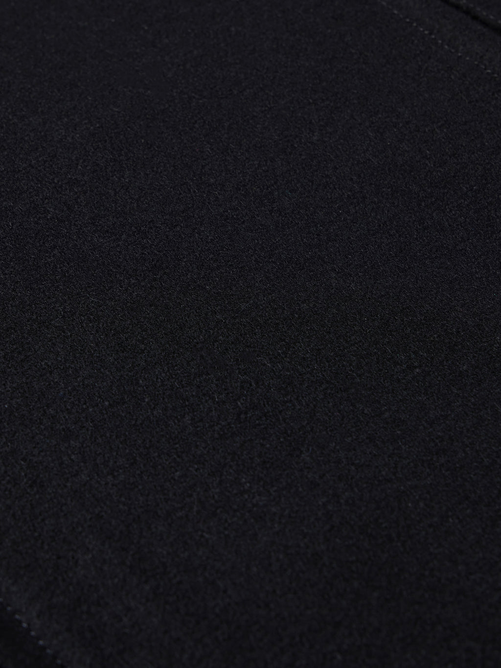 Black wool arena jacket fabric close-up with fine textured weave
