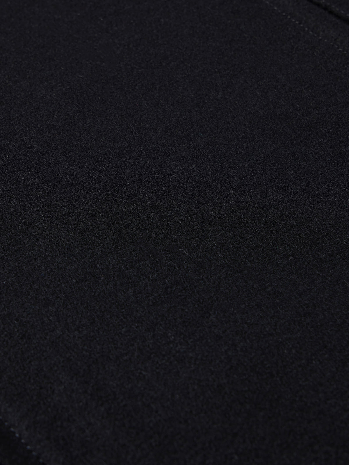 Black wool arena jacket fabric close-up with fine textured weave