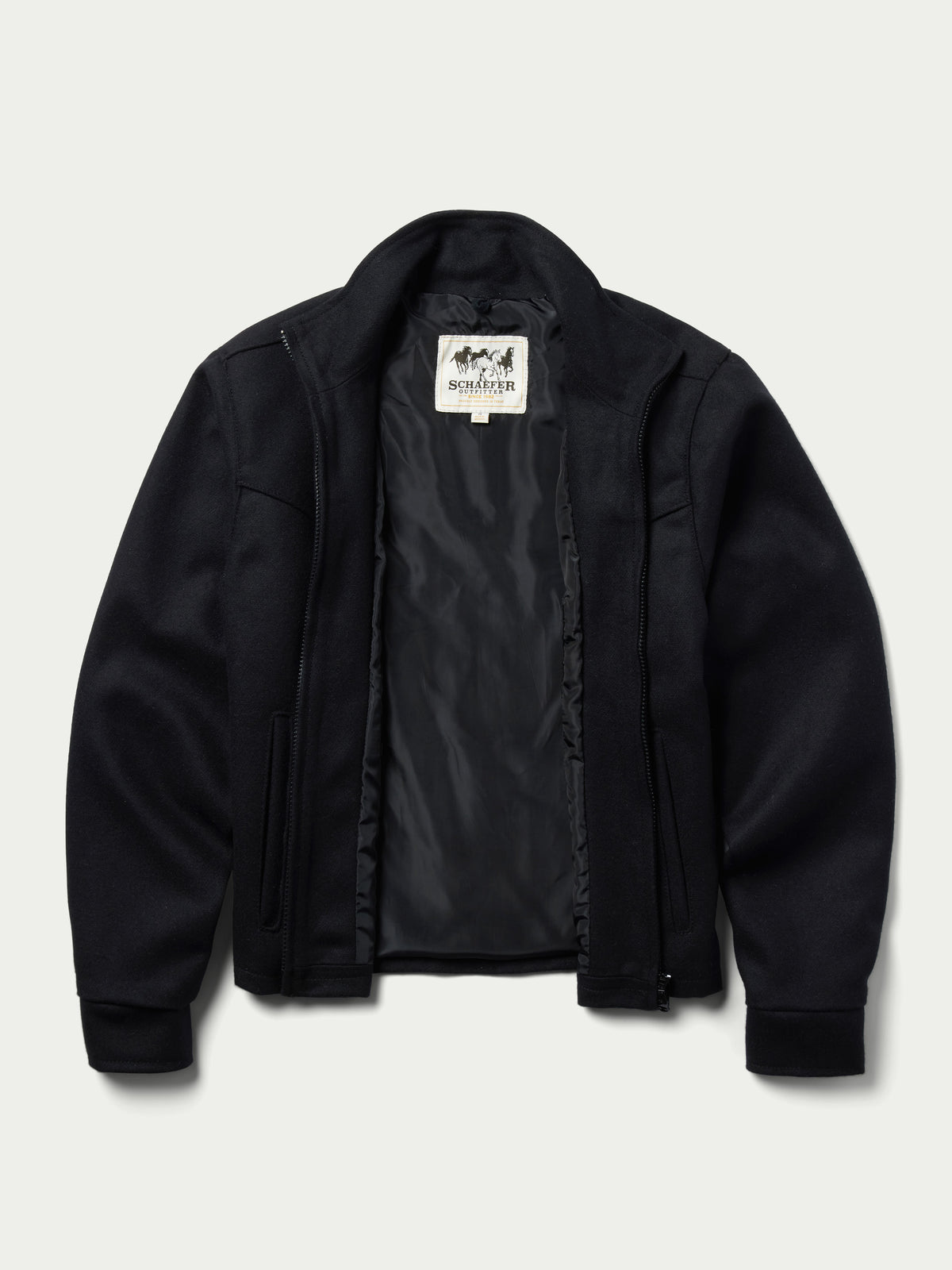 Women's black wool arena jacket with inner plaid lining visible at the zipper