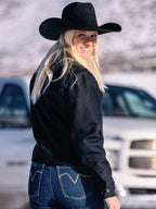 Women's black wool arena jacket on person, side view with stand collar and sleeves